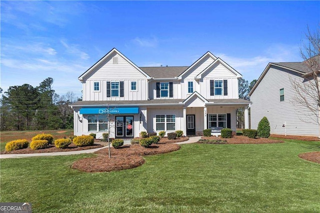 craftsman-style house with board and batten siding and a front yard