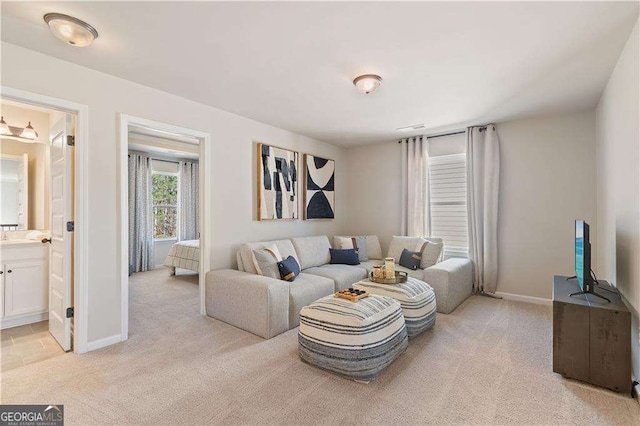 living room featuring light carpet, visible vents, and baseboards