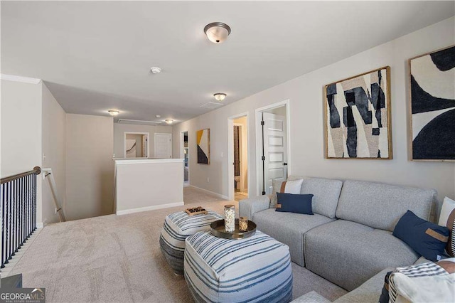 living area with baseboards and light carpet