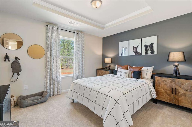 carpeted bedroom with visible vents, baseboards, a tray ceiling, and crown molding
