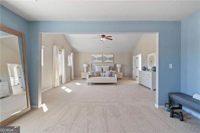 bedroom with lofted ceiling, baseboards, light colored carpet, and visible vents