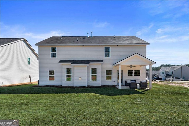 back of property with cooling unit, a ceiling fan, a patio area, a yard, and an outdoor living space