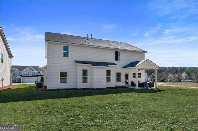 back of house with cooling unit, a yard, and a patio