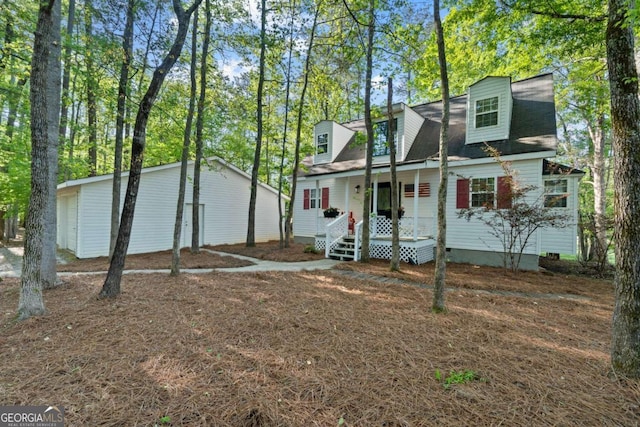 cape cod-style house with a porch, crawl space, and a detached garage