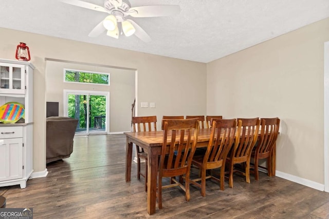dining area with dark wood-type flooring, baseboards, and ceiling fan