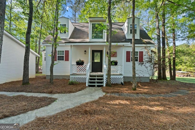 new england style home with a porch and a chimney