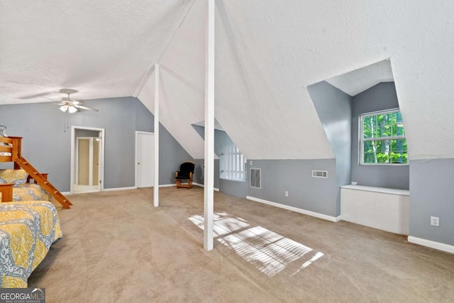 unfurnished bedroom with vaulted ceiling, carpet floors, visible vents, and baseboards