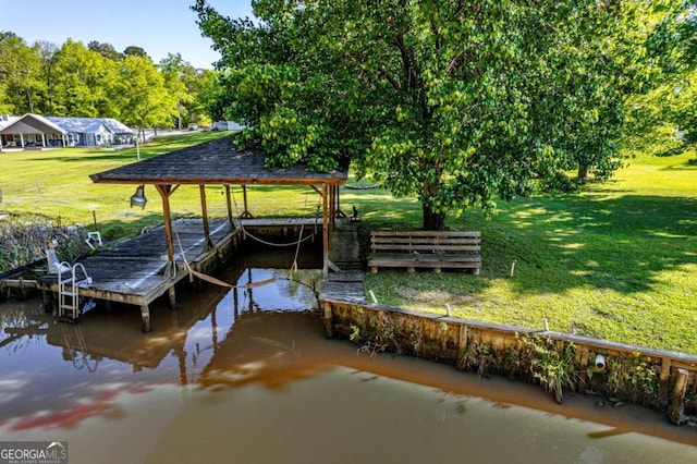dock area featuring a yard and a water view