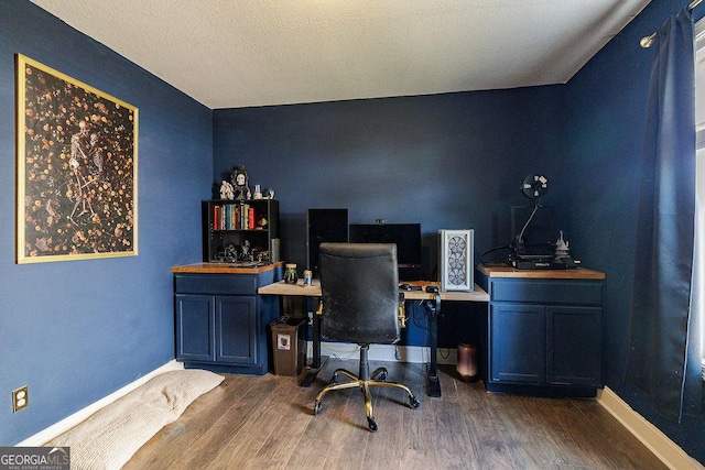 office area featuring baseboards and wood finished floors