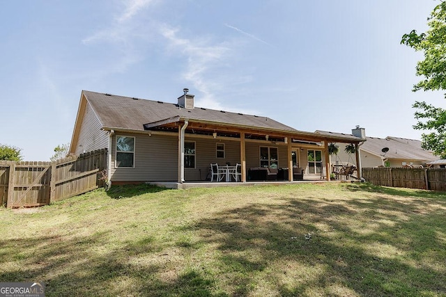rear view of house featuring a fenced backyard, a chimney, outdoor lounge area, a patio area, and a yard