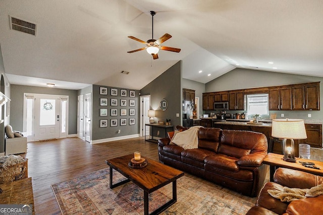 living area featuring ceiling fan, baseboards, wood finished floors, and visible vents