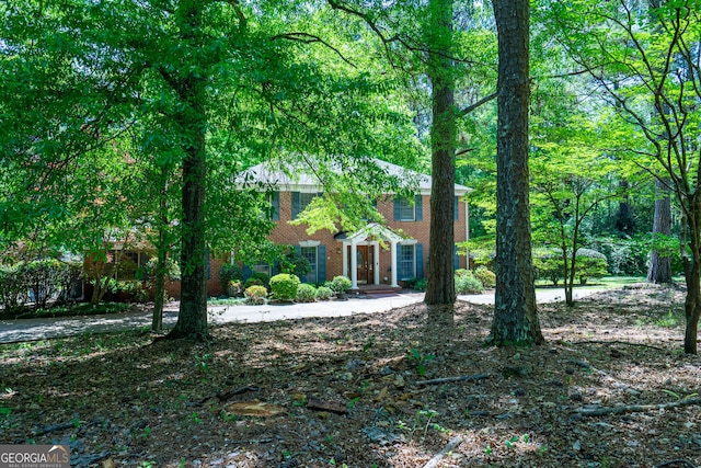 colonial-style house with brick siding