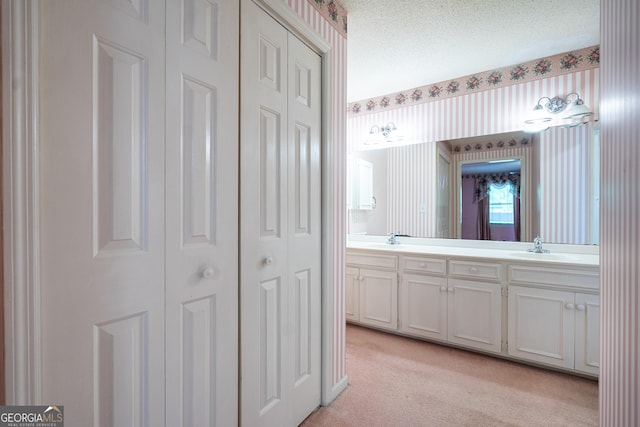 full bath featuring carpet, a sink, a closet, and double vanity