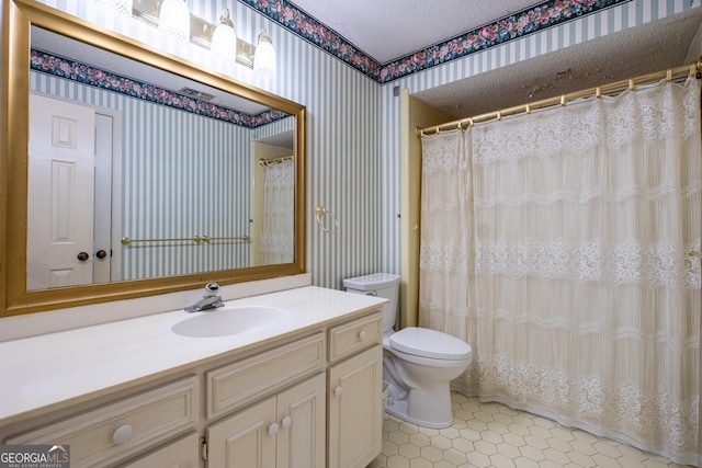 full bath with wallpapered walls, tile patterned floors, toilet, vanity, and a textured ceiling