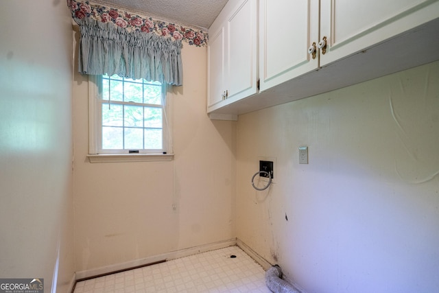 washroom featuring baseboards, cabinet space, tile patterned floors, and a textured ceiling