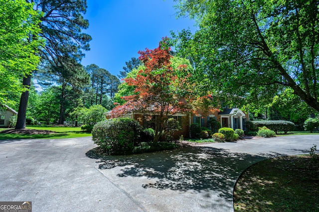 view of home's exterior featuring curved driveway