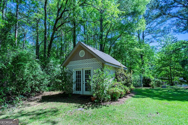 view of outdoor structure featuring french doors and an outbuilding