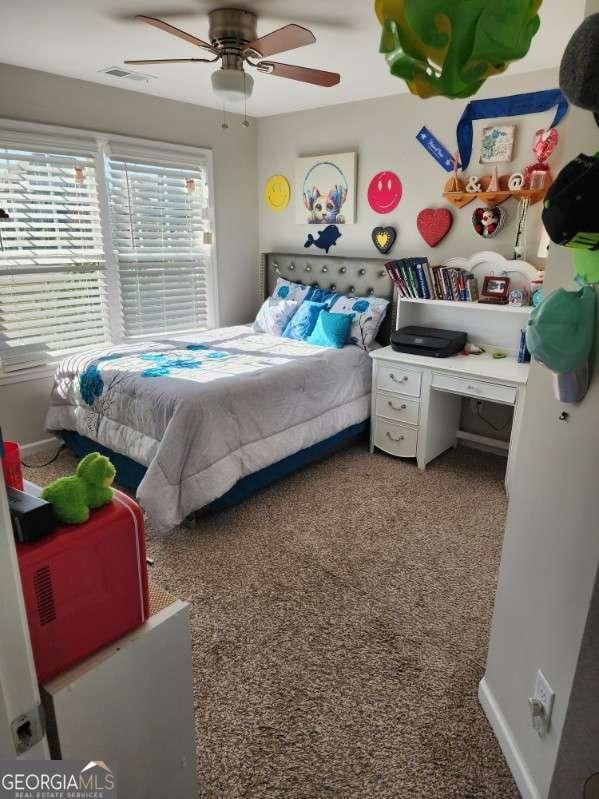 134 Sierra Cir, Woodstock, GA 30188 - carpeted bedroom with baseboards, a ceiling fan, and visible vents
