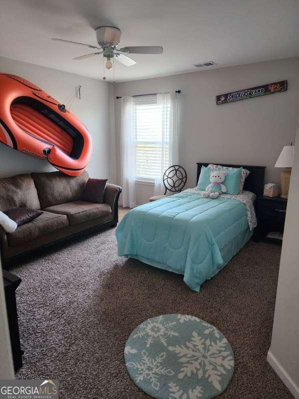 134 Sierra Cir, Woodstock, GA 30188 - carpeted bedroom with visible vents, baseboards, and ceiling fan