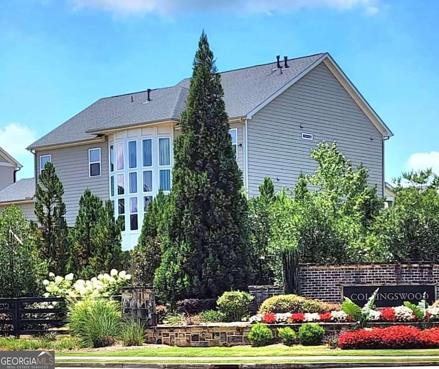 134 Sierra Cir, Woodstock, GA 30188 - rear view of property featuring a shingled roof and fence
