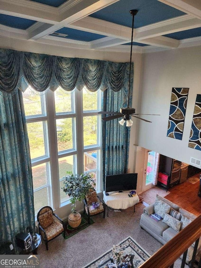134 Sierra Cir, Woodstock, GA 30188 - living area with coffered ceiling, crown molding, carpet flooring, and beamed ceiling