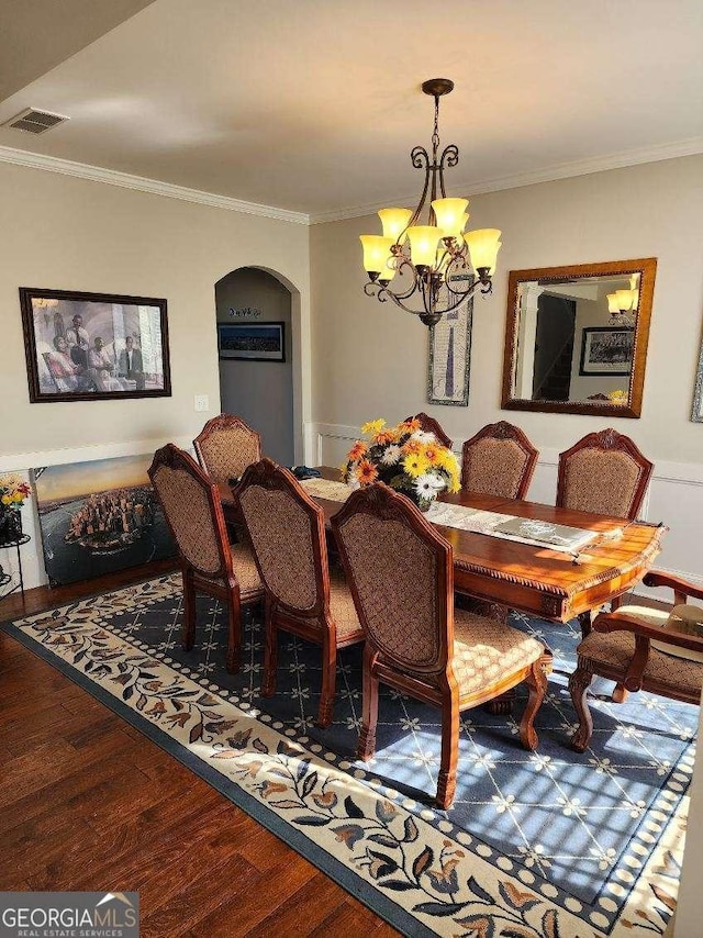 134 Sierra Cir, Woodstock, GA 30188 - dining space with wood finished floors, arched walkways, a chandelier, and ornamental molding