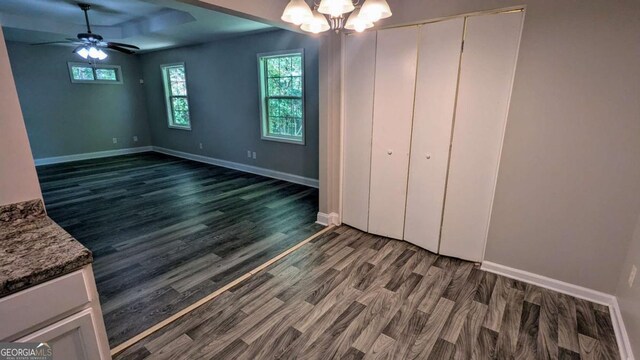 685 Greenhedge Dr, Stone Mountain, GA 30088 - unfurnished dining area with wood finished floors, plenty of natural light, ceiling fan, and a chandelier