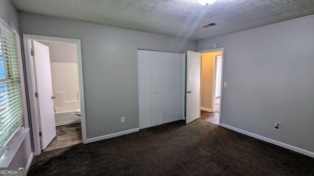 685 Greenhedge Dr, Stone Mountain, GA 30088 - unfurnished bedroom featuring a textured ceiling, carpet flooring, a closet, and connected bathroom