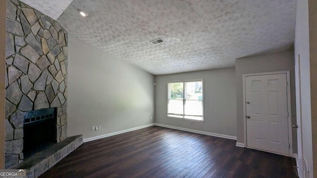 685 Greenhedge Dr, Stone Mountain, GA 30088 - unfurnished living room featuring dark wood-type flooring, a textured ceiling, and a fireplace