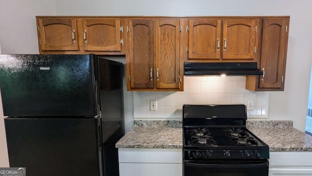 685 Greenhedge Dr, Stone Mountain, GA 30088 - kitchen featuring black appliances, under cabinet range hood, backsplash, and brown cabinets