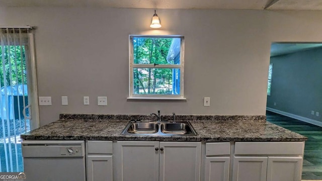 685 Greenhedge Dr, Stone Mountain, GA 30088 - kitchen with dishwasher, wood finished floors, healthy amount of natural light, and dark countertops