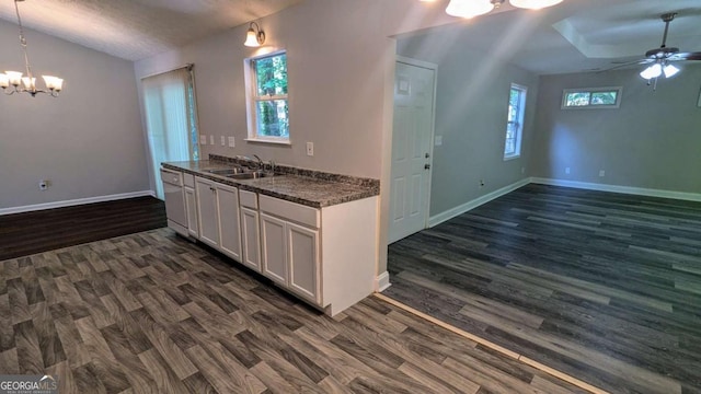 685 Greenhedge Dr, Stone Mountain, GA 30088 - kitchen with a chandelier, dark wood-style floors, dark countertops, ceiling fan, and vaulted ceiling
