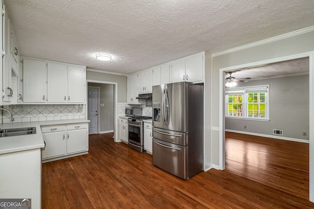 1320 Pinyon Pl, Lawrenceville, GA 30043 - kitchen featuring a sink, dark wood finished floors, light countertops, appliances with stainless steel finishes, and tasteful backsplash