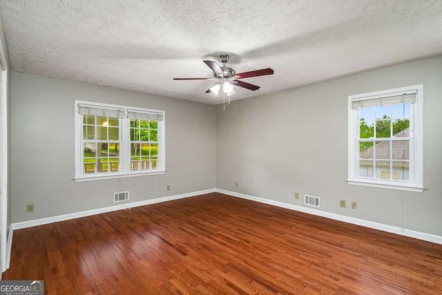 1320 Pinyon Pl, Lawrenceville, GA 30043 - empty room with ceiling fan, visible vents, plenty of natural light, and wood finished floors