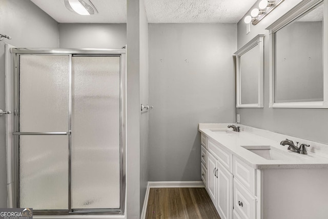 1320 Pinyon Pl, Lawrenceville, GA 30043 - bathroom with a sink, a stall shower, baseboards, and wood finished floors