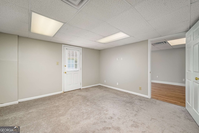 1320 Pinyon Pl, Lawrenceville, GA 30043 - below grade area featuring a paneled ceiling, baseboards, visible vents, and carpet