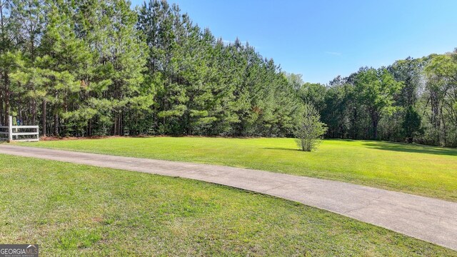 5800 S Richland Creek Rd, Buford, GA 30518 - view of community featuring fence, a view of trees, and a yard