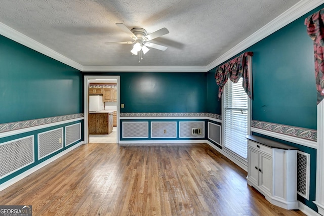 5800 S Richland Creek Rd, Buford, GA 30518 - unfurnished living room featuring ceiling fan, a healthy amount of sunlight, a wainscoted wall, and wood finished floors