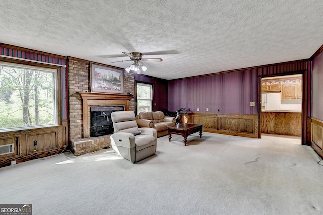 5800 S Richland Creek Rd, Buford, GA 30518 - living room with wooden walls, a brick fireplace, a textured ceiling, and a ceiling fan