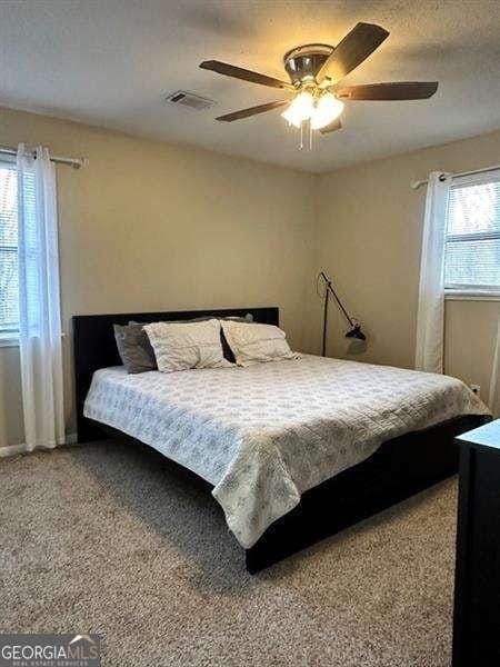 6630 Crystal Cove Trl, Gainesville, GA 30506 - bedroom featuring ceiling fan, visible vents, and carpet