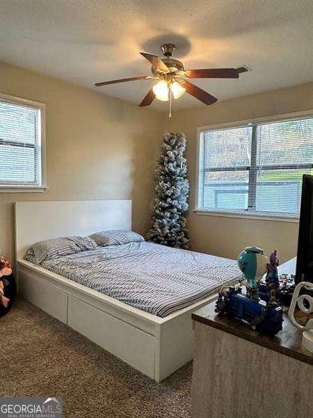 6630 Crystal Cove Trl, Gainesville, GA 30506 - carpeted bedroom with a ceiling fan
