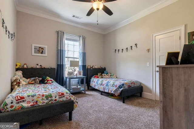 carpeted bedroom with a ceiling fan, visible vents, and crown molding