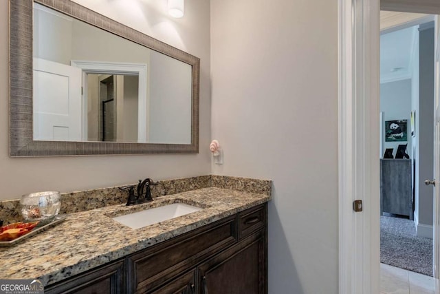 bathroom with tile patterned floors, vanity, and crown molding