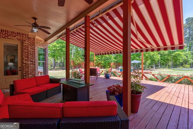 wooden deck with a ceiling fan and an outdoor hangout area