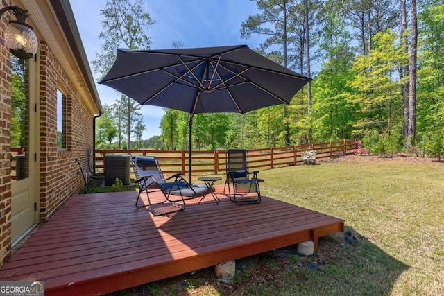 deck featuring a lawn and fence