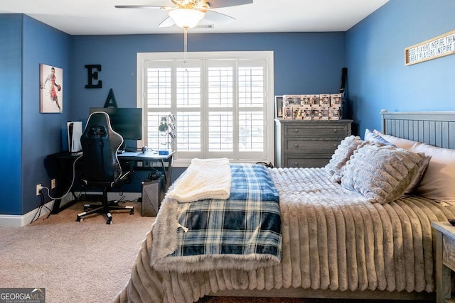 carpeted bedroom with a ceiling fan and baseboards