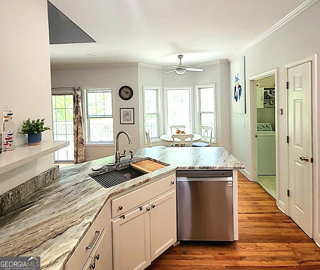 kitchen featuring ceiling fan, crown molding, stainless steel dishwasher, a sink, and dark wood-style floors