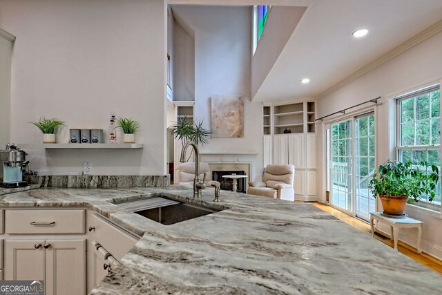 327 Kissimmee Trl, Cornelia, GA 30531 - kitchen featuring a sink, light stone counters, a fireplace, recessed lighting, and open shelves