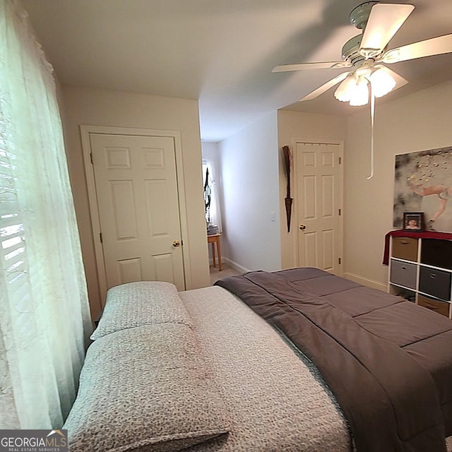 bedroom with baseboards and a ceiling fan