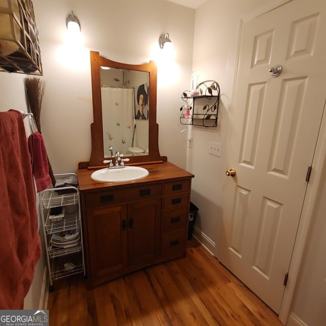 bathroom featuring vanity, wood finished floors, and a shower with shower curtain